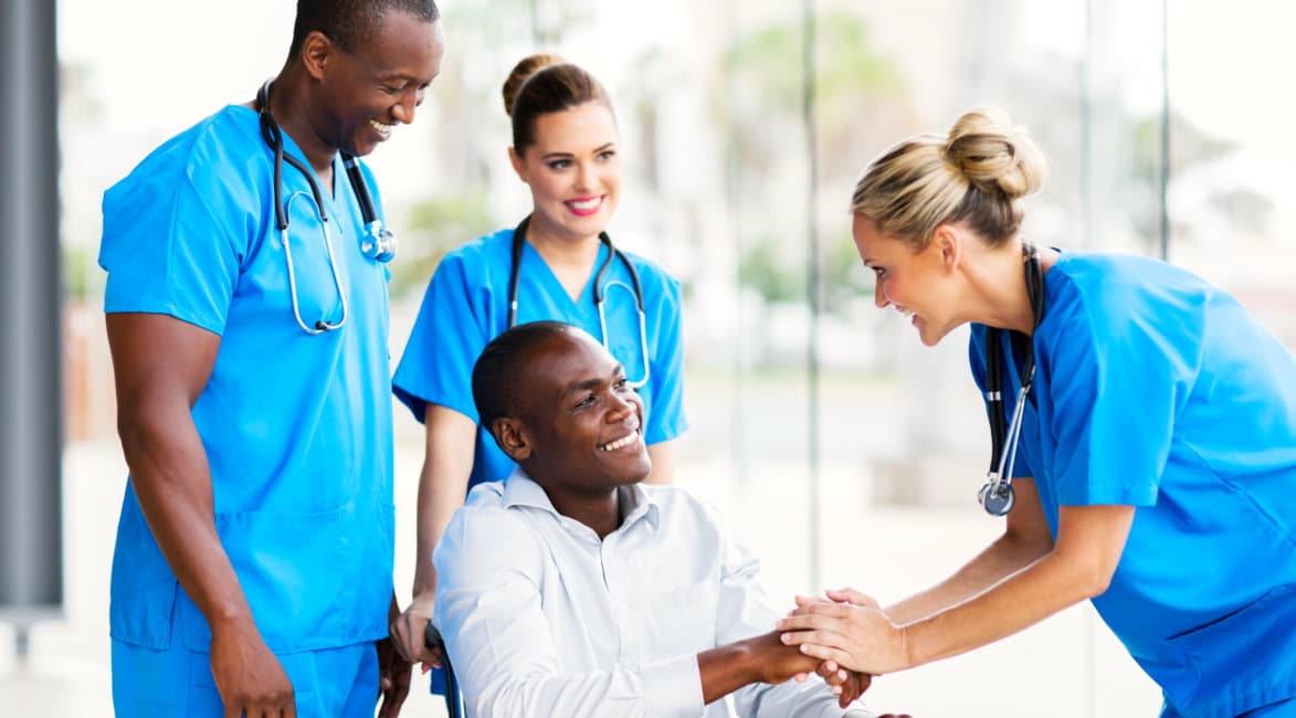 medical staffs and man in a wheelchair