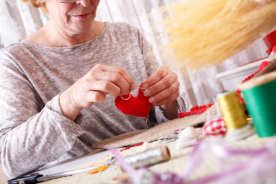 senior woman sewing